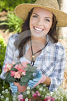Smiling Young Adult Woman Wearing Hat Gardening Outdoors