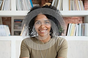 Smiling young african american woman looking at camera webcam photo