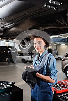 smiling young african american mechanic in