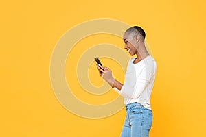 Smiling young African American woman using smartphone