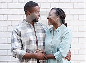 Affectionate young African couple standing together in the city