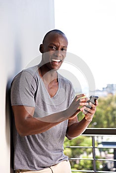 Smiling young african man with cell phone