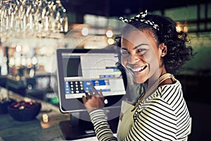 Smiling African waitress using a restaurant point of sale termin photo