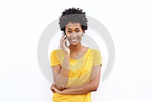 Smiling young african woman talking on cell phone