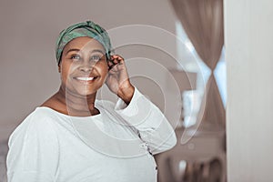 Smiling young African woman wearing on a stylish headscarf