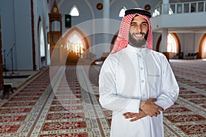 Smiling young arabian man posing inside the mosque