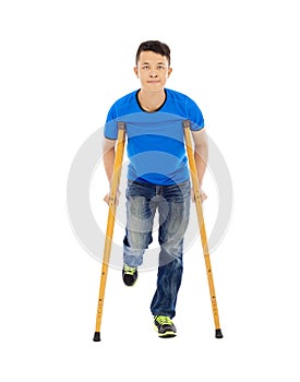 Smiling Young asian man on crutches.