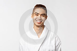 Smiling young asian in white bathrobe Portrait studio isolated.