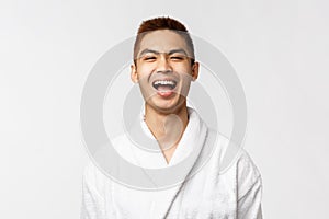 Smiling young asian in white bathrobe Portrait studio isolated.