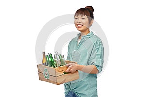 smiling young asian woman sorting glass waste