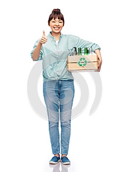 smiling young asian woman sorting glass waste