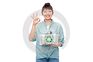 smiling young asian woman sorting metallic waste