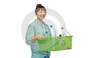 smiling young asian woman sorting plastic waste