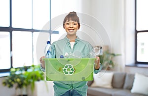 smiling young asian woman sorting plastic waste