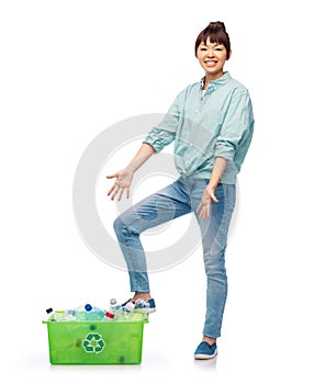 smiling young asian woman sorting plastic waste