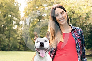 Smiling young attractive woman portrait with her cute dog