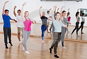 Smiling young ballet dancers exercising