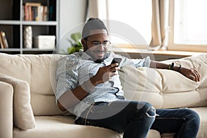 Smiling young biracial man using mobile applications.