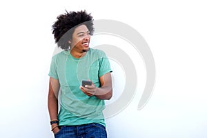 Smiling young black man holding cellphone