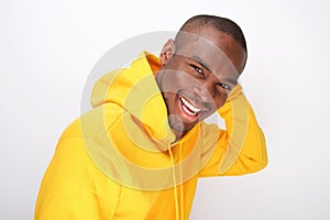 Smiling young black man with hoodie against white background