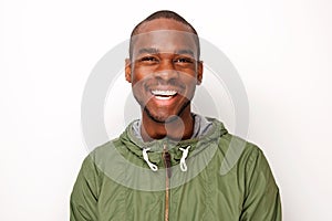 Smiling young black man with windbreaker against isolated white background photo