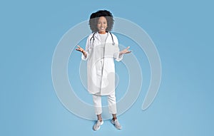 Smiling young black woman doctor therapist in white coat hold copy space on hands