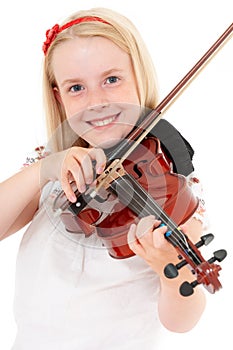 Smiling young blonde girl plays violin on a white studio background