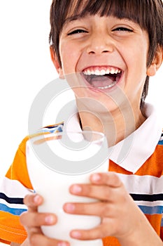 Smiling young boy holding a glass of milk