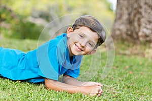 Smiling young boy lying on grass