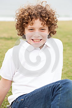 Smiling young boy posing casually