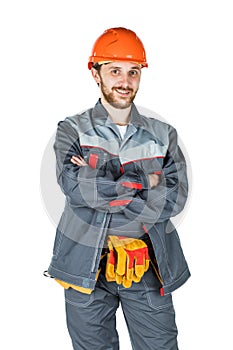 Smiling young builder, looking at camera. Repair and construction. Isolated over white background.