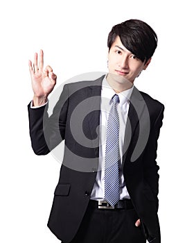 Smiling young business man with okay gesture