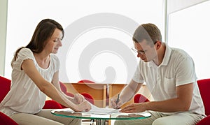 Smiling young business people signing a contract