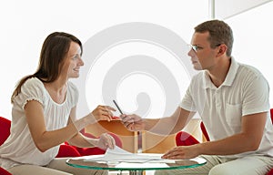 Smiling young business people signing a contract