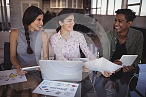 Smiling young business people working together at office