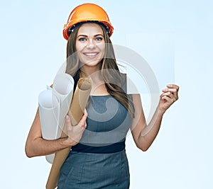 Smiling young business woman architect holding white empty advertising banner.