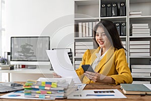 Smiling young business woman, happy beautiful professional lady worker holding smartphone using cellphone mobile working