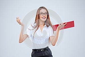 The smiling young business woman with pen and tablet for notes on gray background