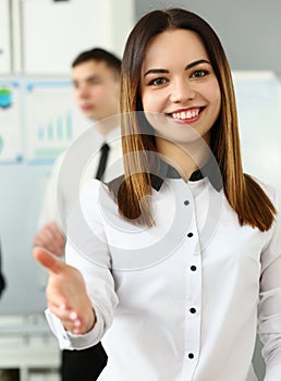 Smiling young business woman politely greets company office