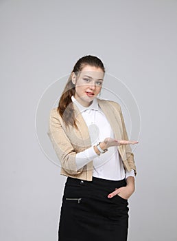 Smiling young business woman showing blank area