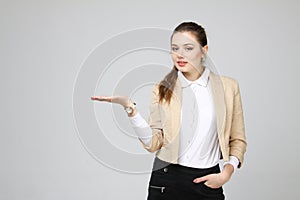 Smiling young business woman showing blank area