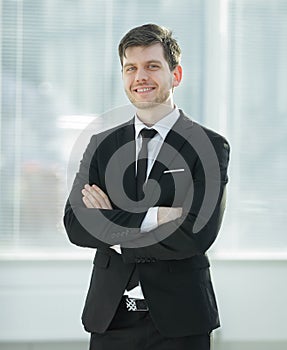 Smiling young businessman on blurred background office