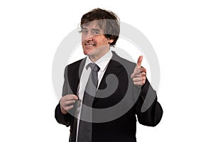 Smiling young businessman with his hand gestures imitating gun pointed straight to camera.