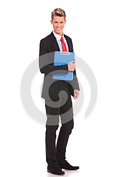 Smiling young businessman with a notepad