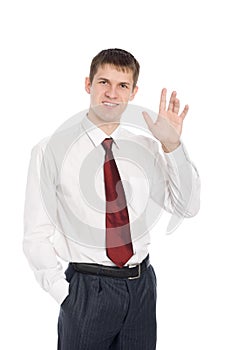 Smiling young businessman with a welcoming gesture