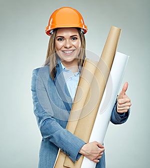 Smiling young businesswoman builder holding paper plan shows thu