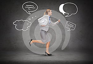 Smiling young businesswoman with clock running