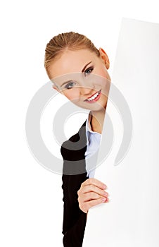 Smiling young businesswoman holding blank banner