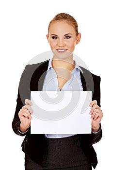 Smiling young businesswoman holding blank banner