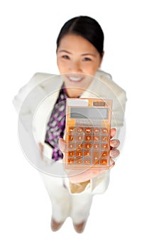 Smiling young businesswoman holding a calculator